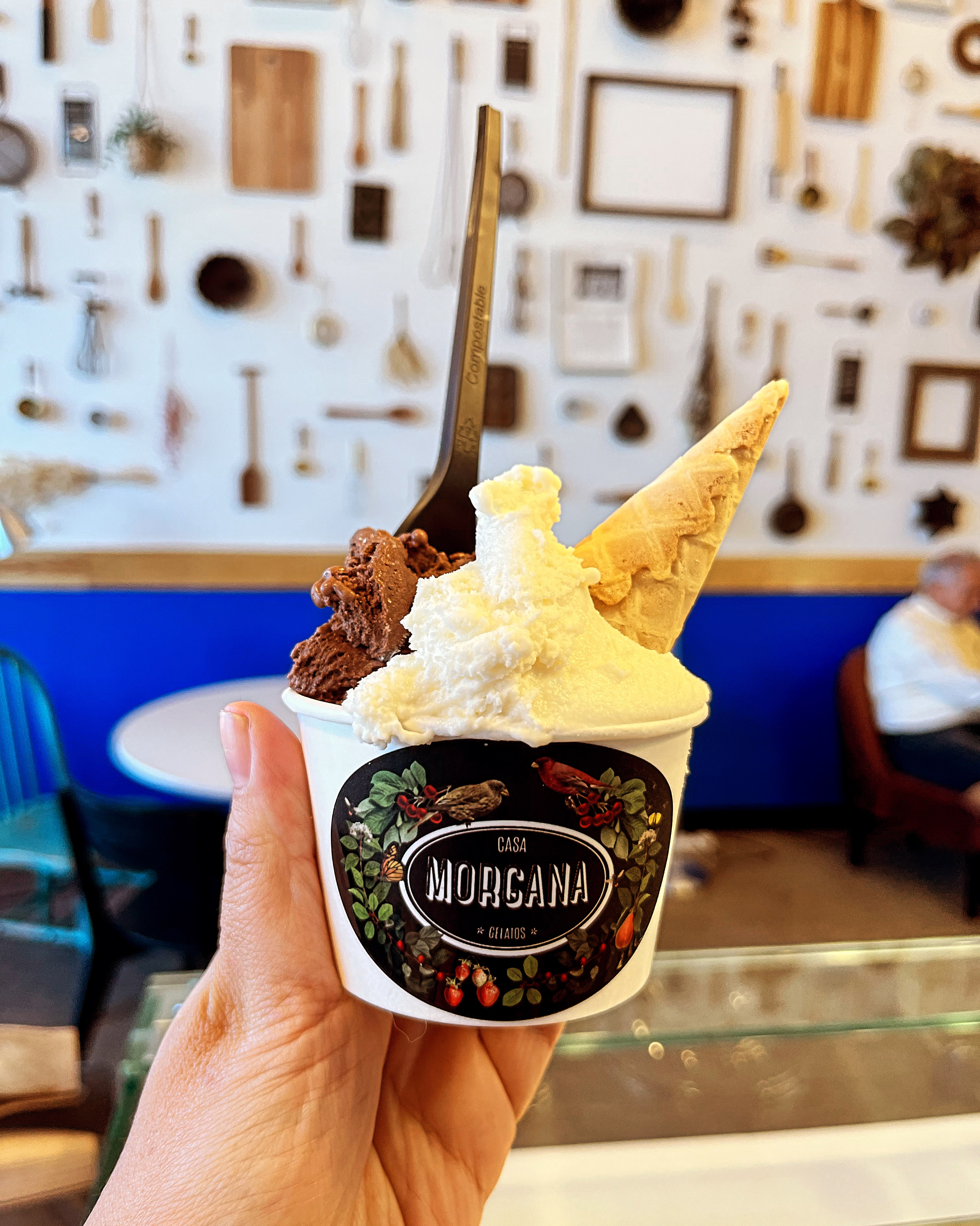 Hand holding a Casa Morgana branded gelato cup with two flavor scoops